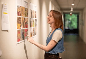 Art student looking at artwork in the hallway